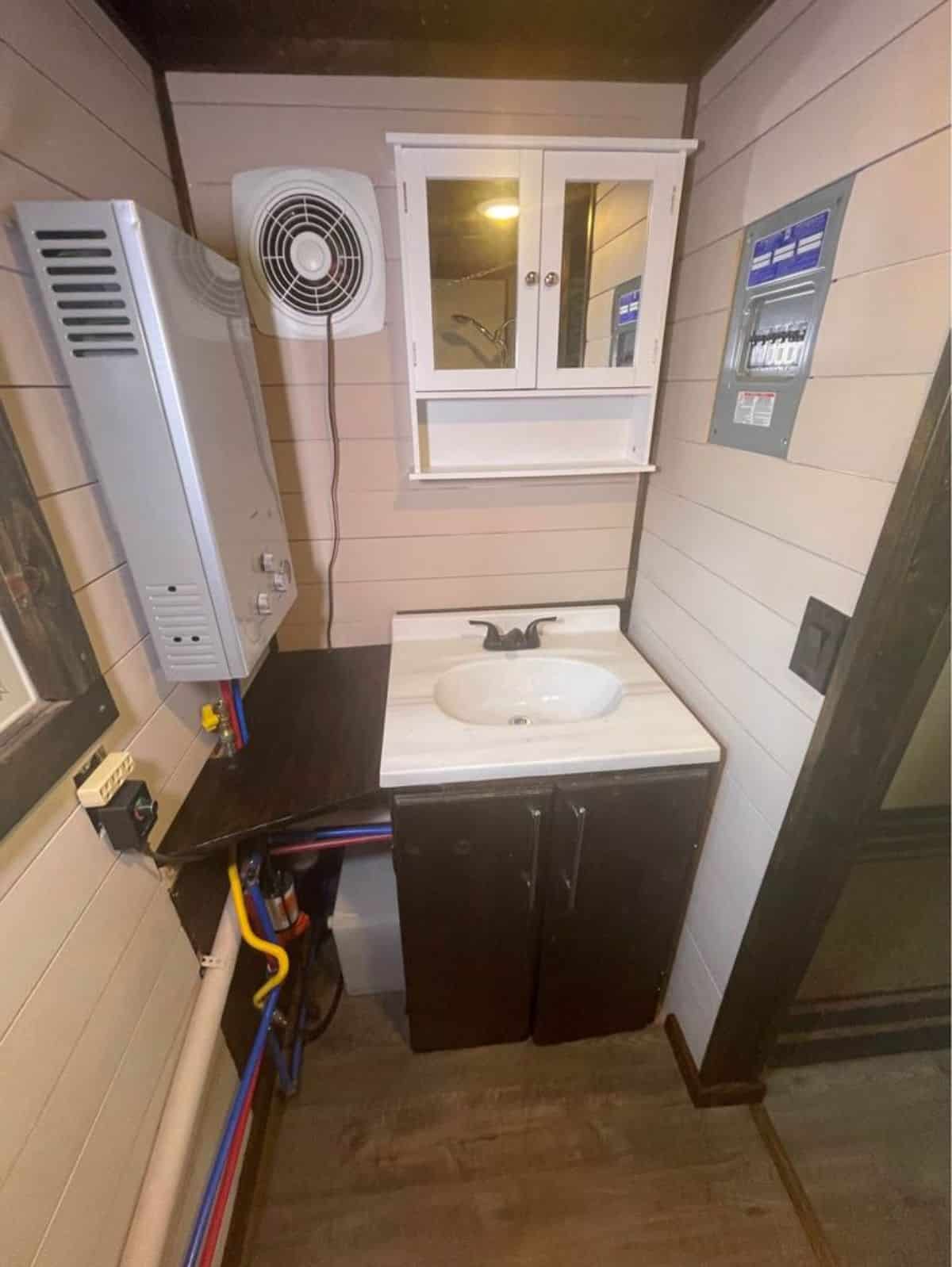 bathroom of one bedroom tiny home has all the standard fittings and a bath tub