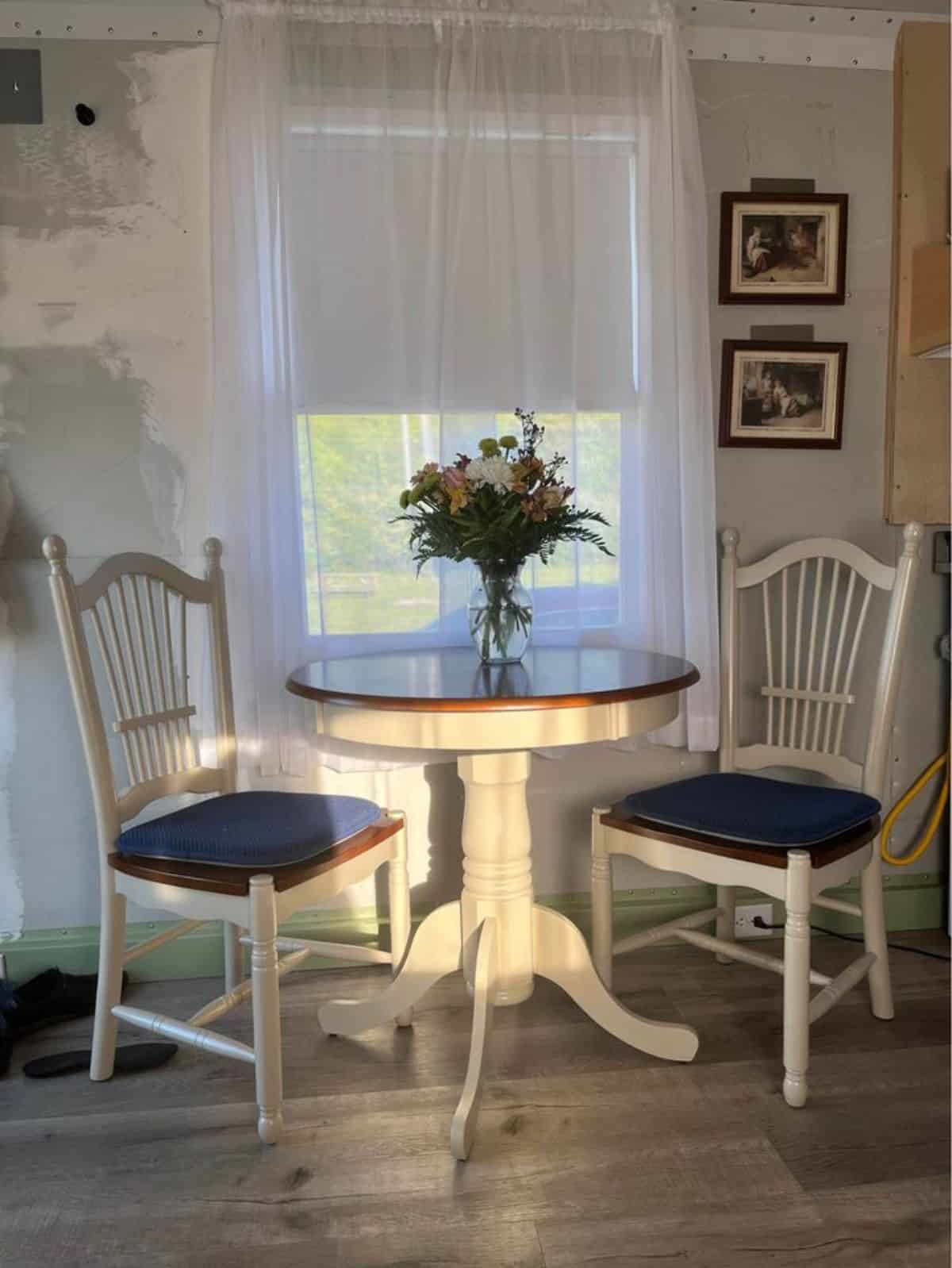 round dining table with chairs in the living area of the house
