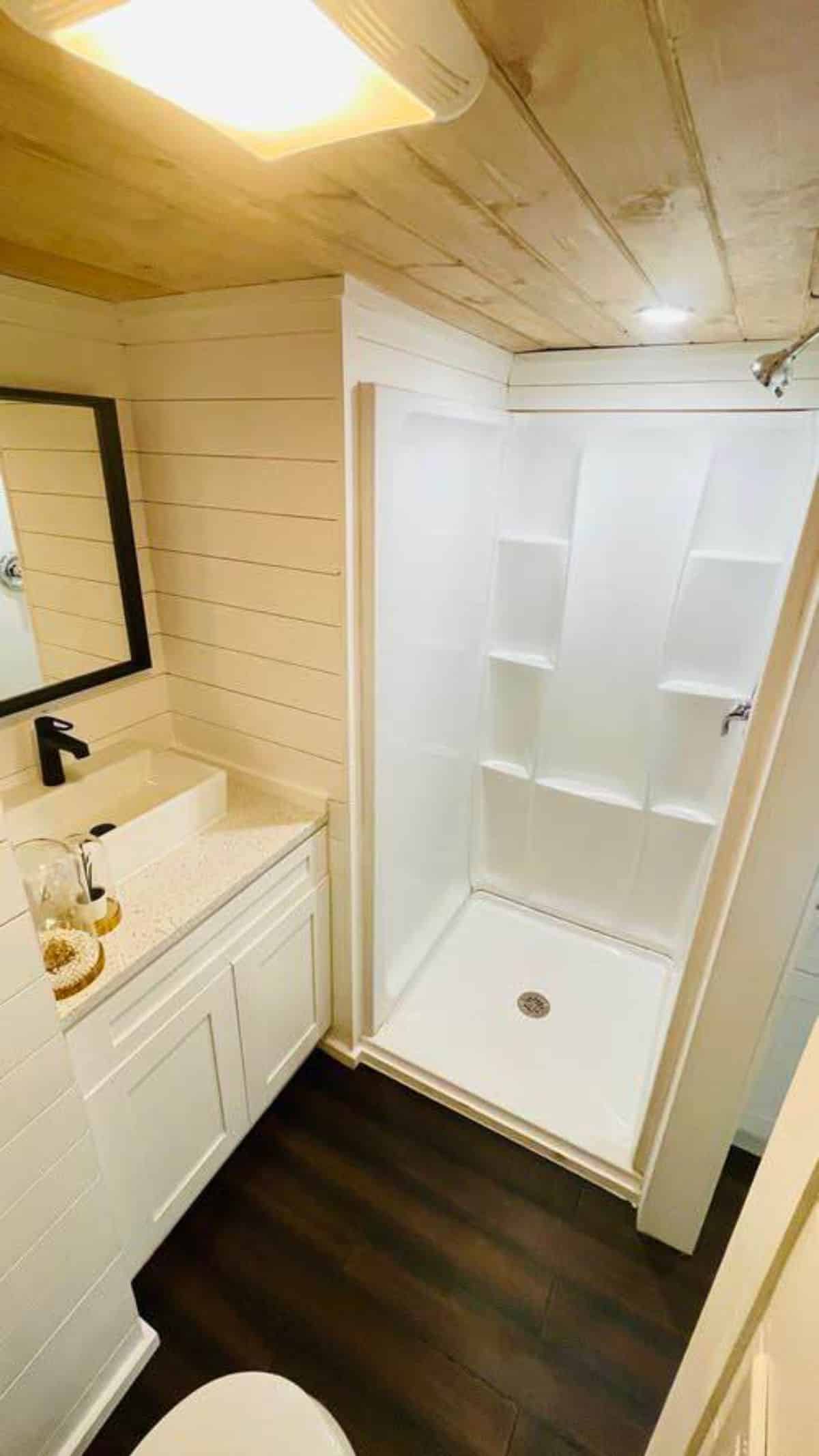 bathroom of 22’ durable tiny home has all the standard fittings