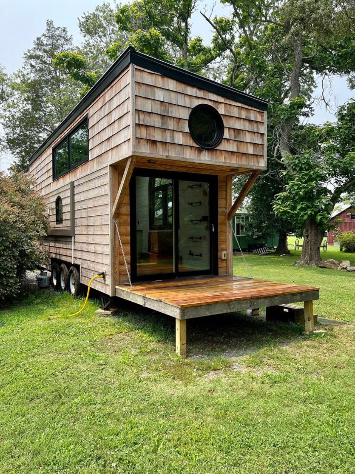 small porch outside the main entrance door of 24' adorable tiny home