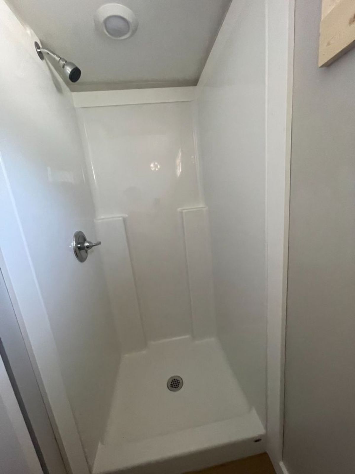 full length shower area in bathroom of tiny home for two