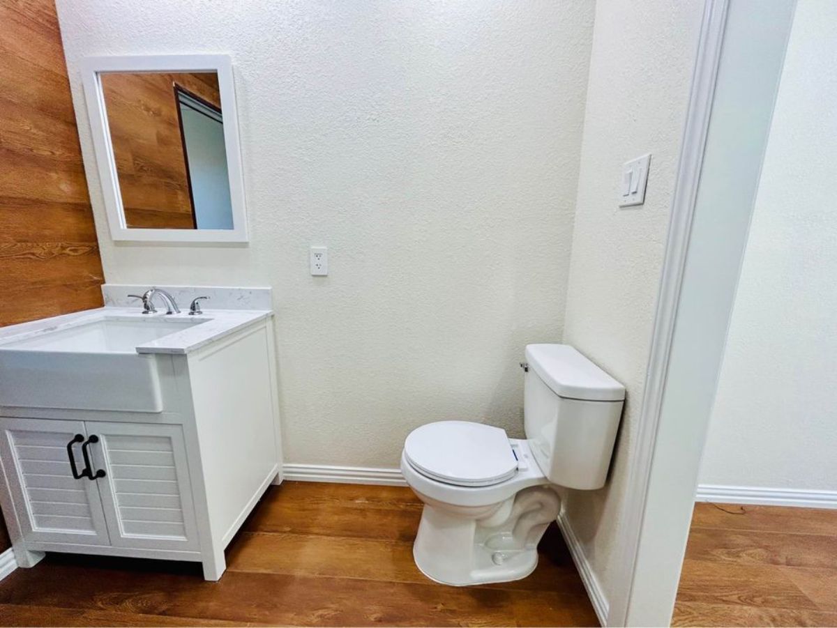 bathroom of brand new container home has a standard fittings and sink with vanity