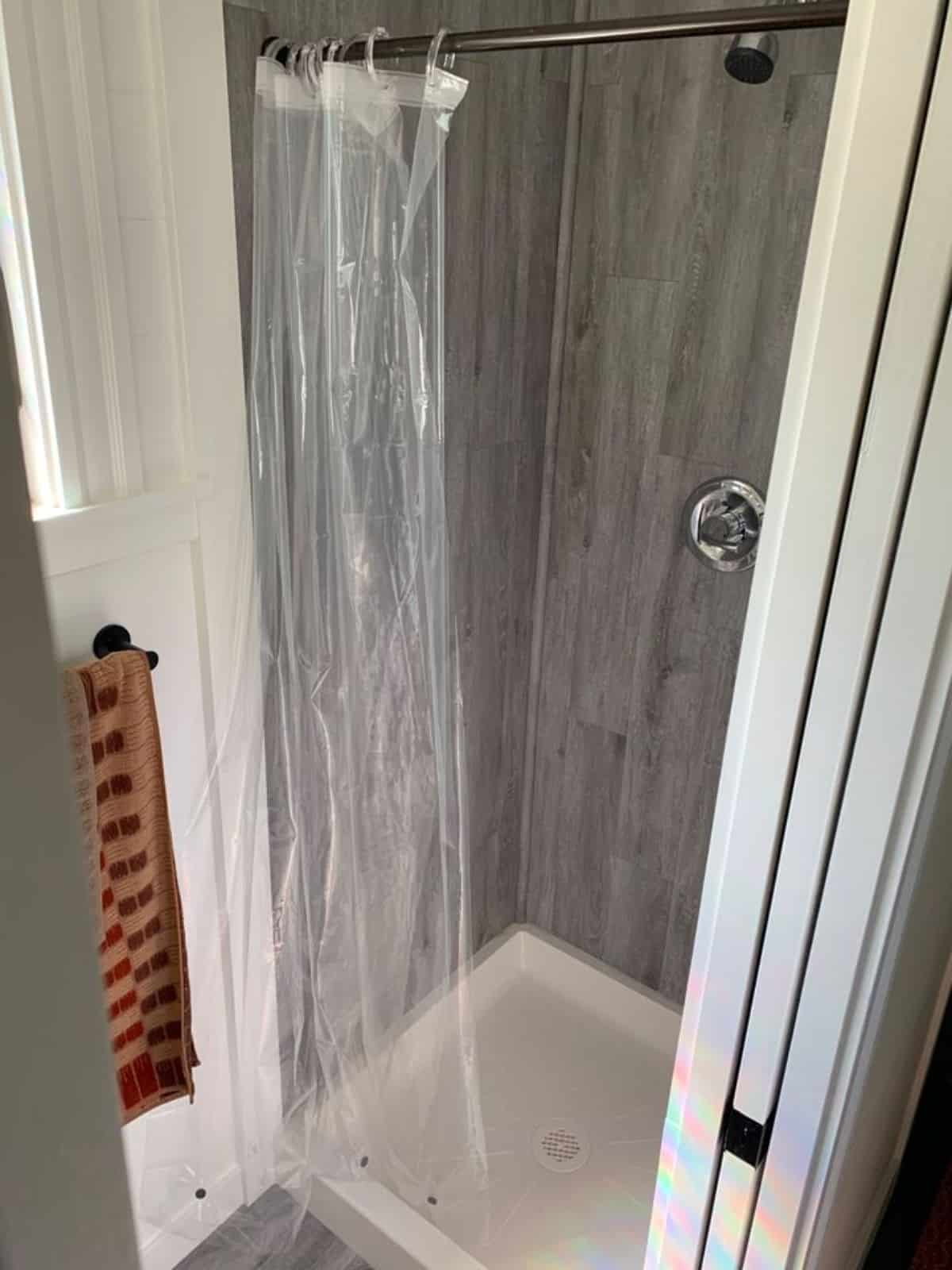 full length shower area with plastic curtains