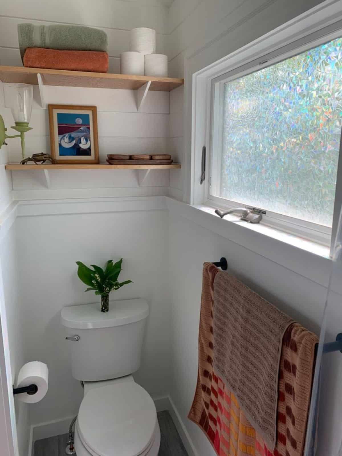bathroom of Brand new tiny home has all standard fittings with wall mounted shelves