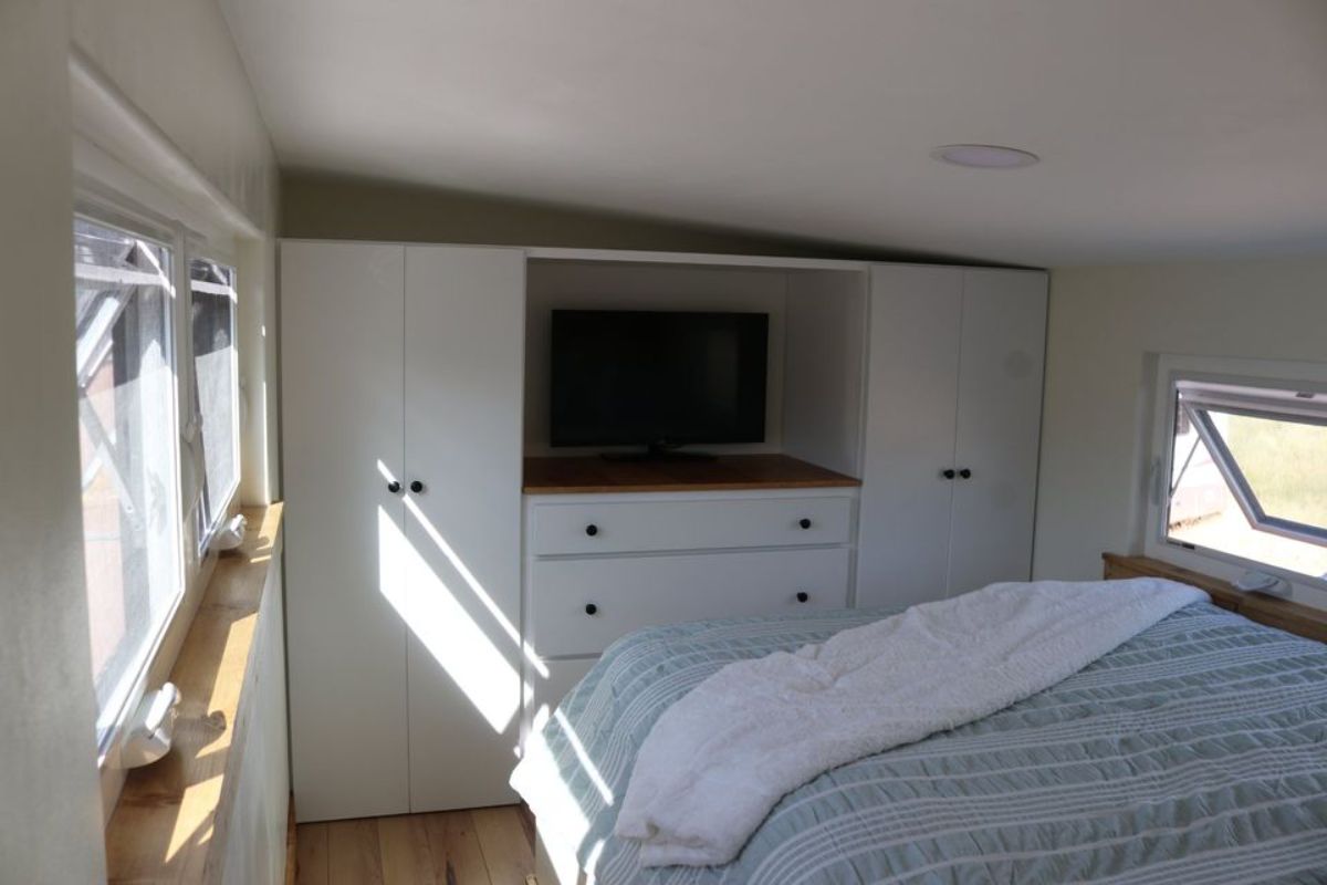 double storage wardrobes with wall mounted TV set