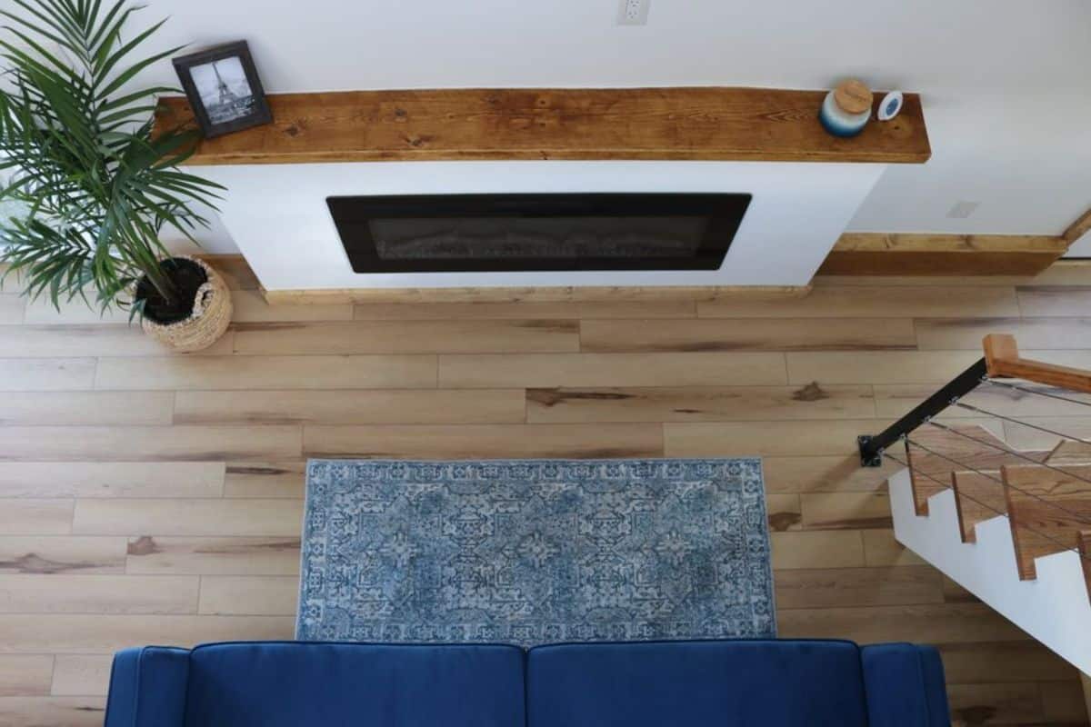 wooden flooring and an electric fireplace in the living area