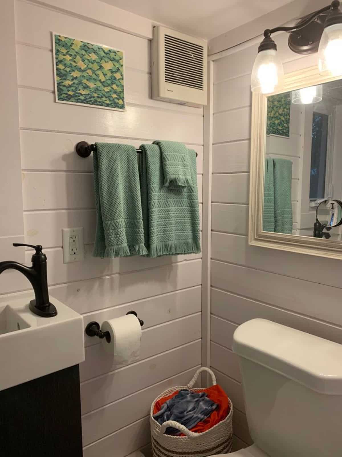 bathroom of furnished tiny home has all the standard fittings