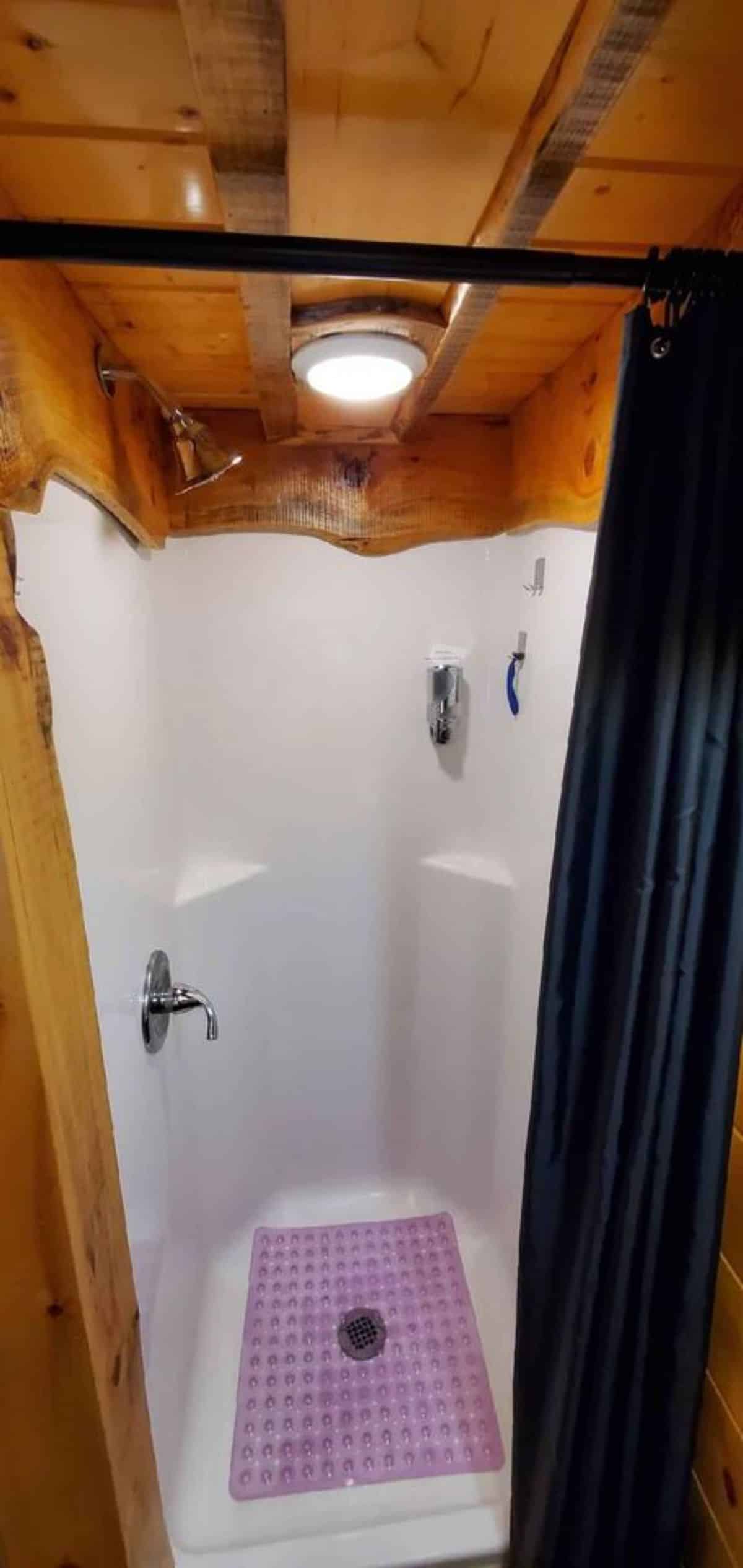 full length shower area in bathroom of mad hatter themed tiny house