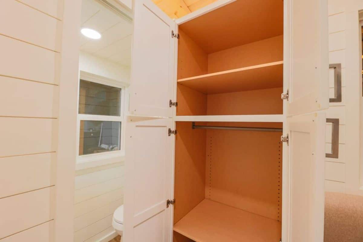 storage cabinets in bedroom of RV certified tiny house