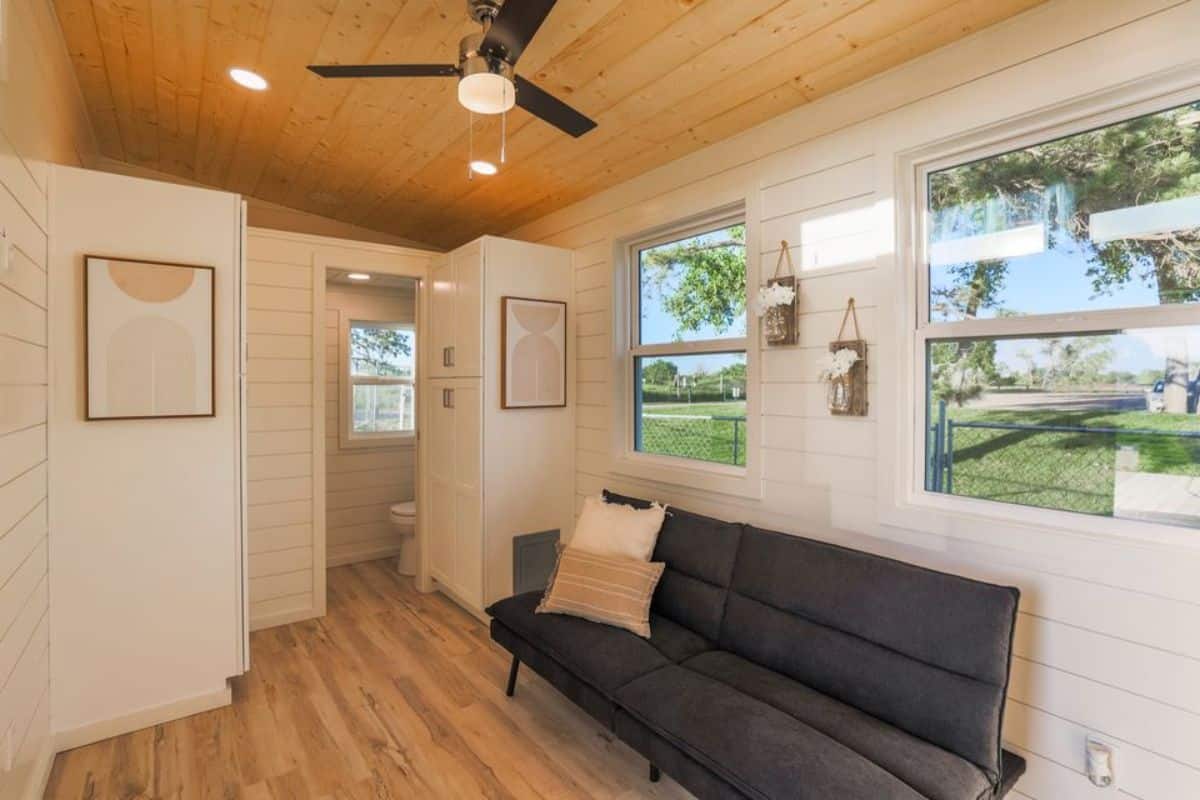 living area of RV certified tiny house has a couch and ample space