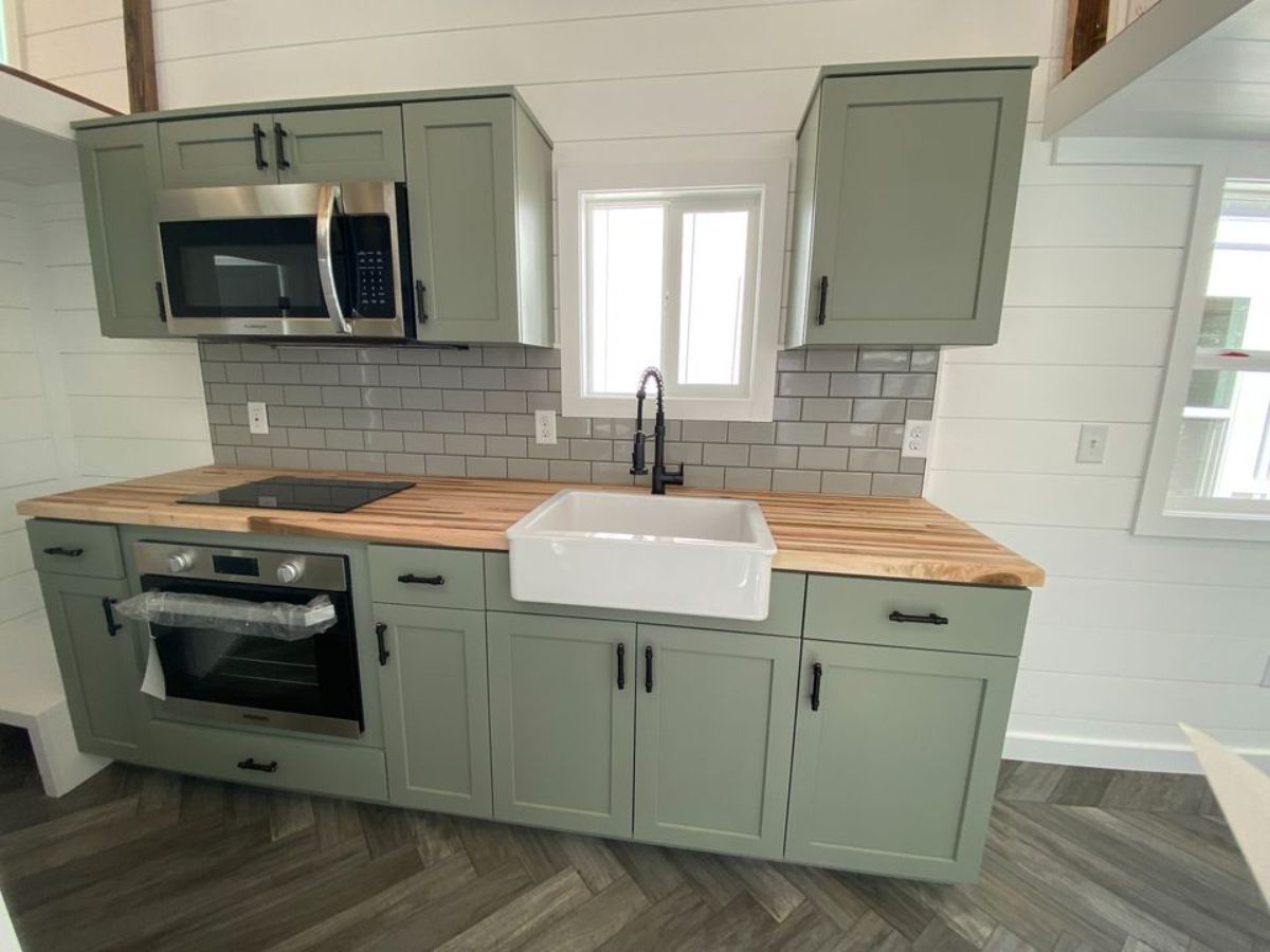 pastel green coloured kitchen area with huge countertop