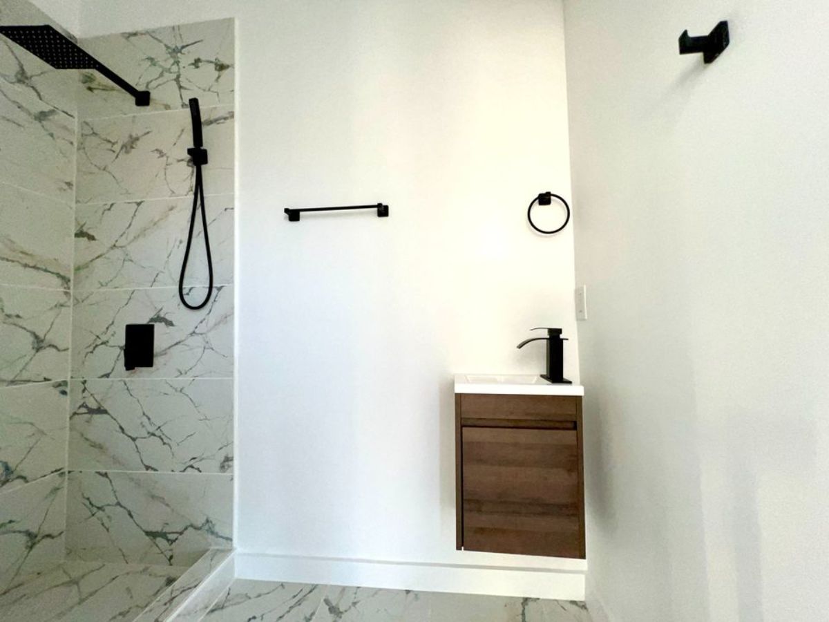 bathroom of super spacious tiny house has all the standard fittings with full length shower