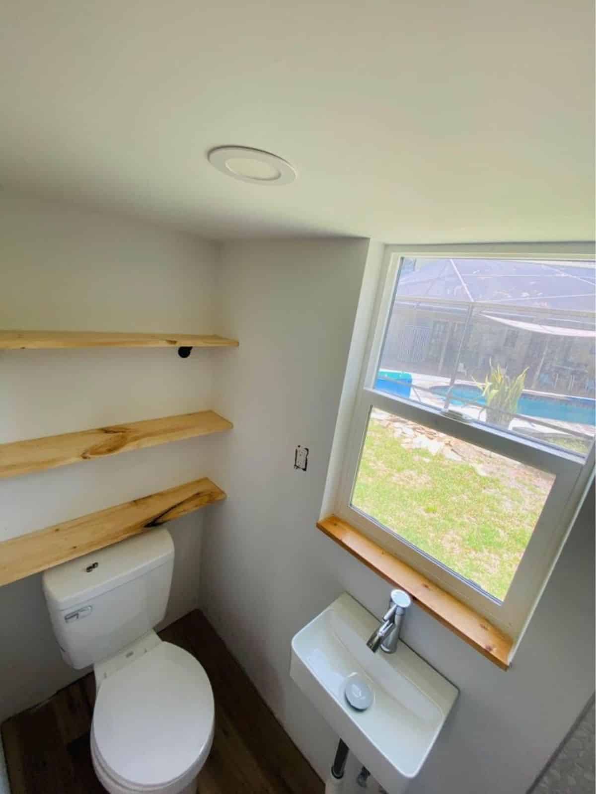 standard toilet and sink installed in bathroom