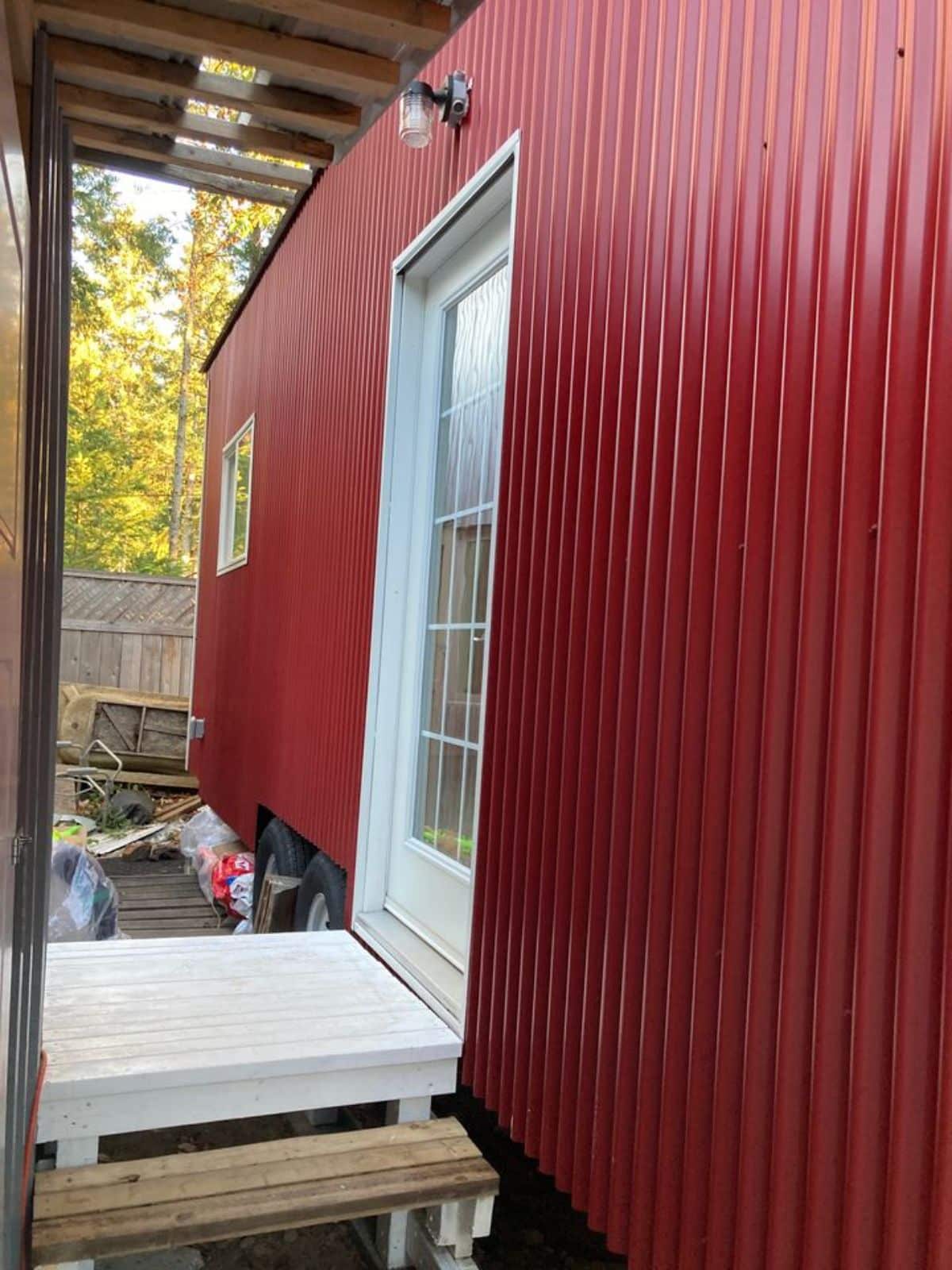 stunning red metal exterior of 26' insulated tiny home