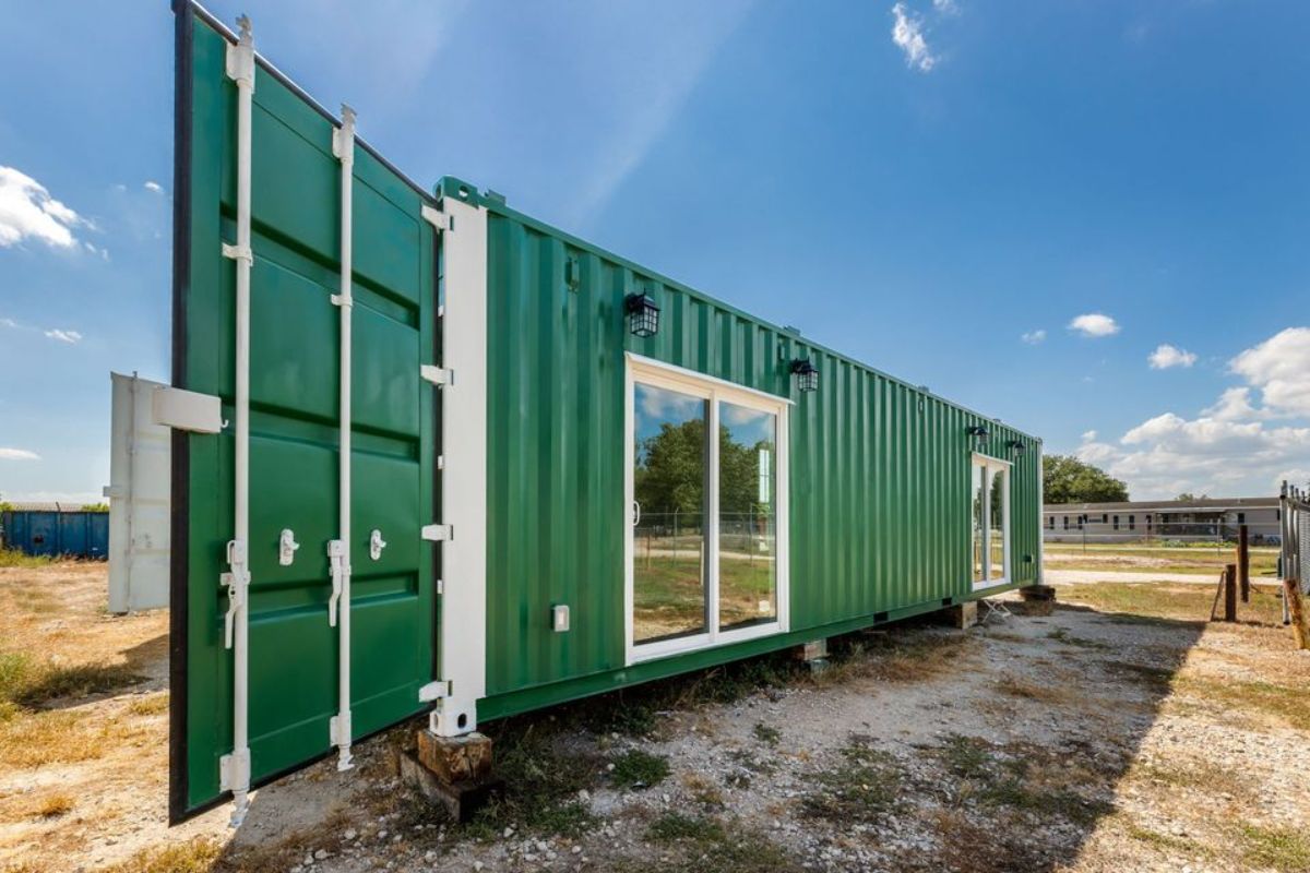 stunning green exterior of 40' luxury container home