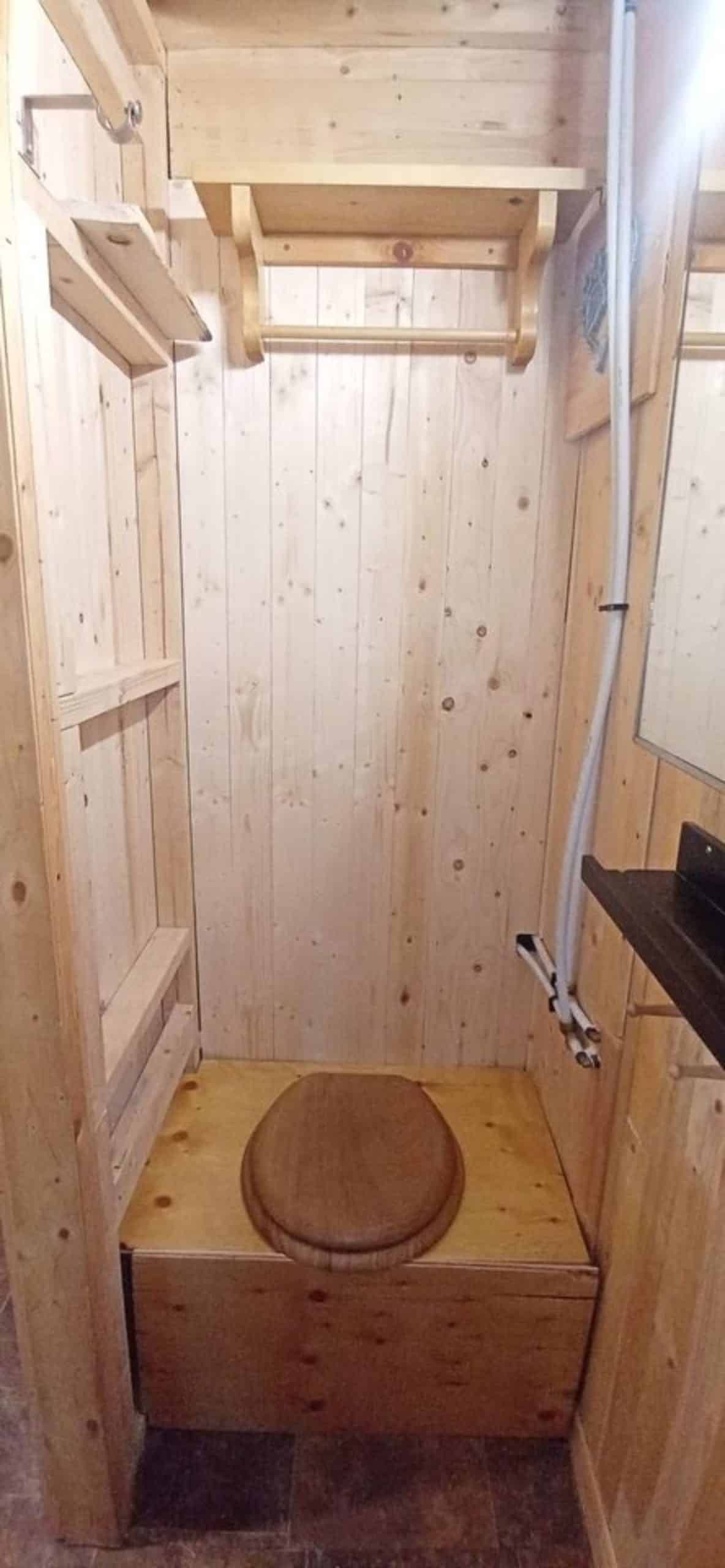 wooden standard toilet in the bathroom