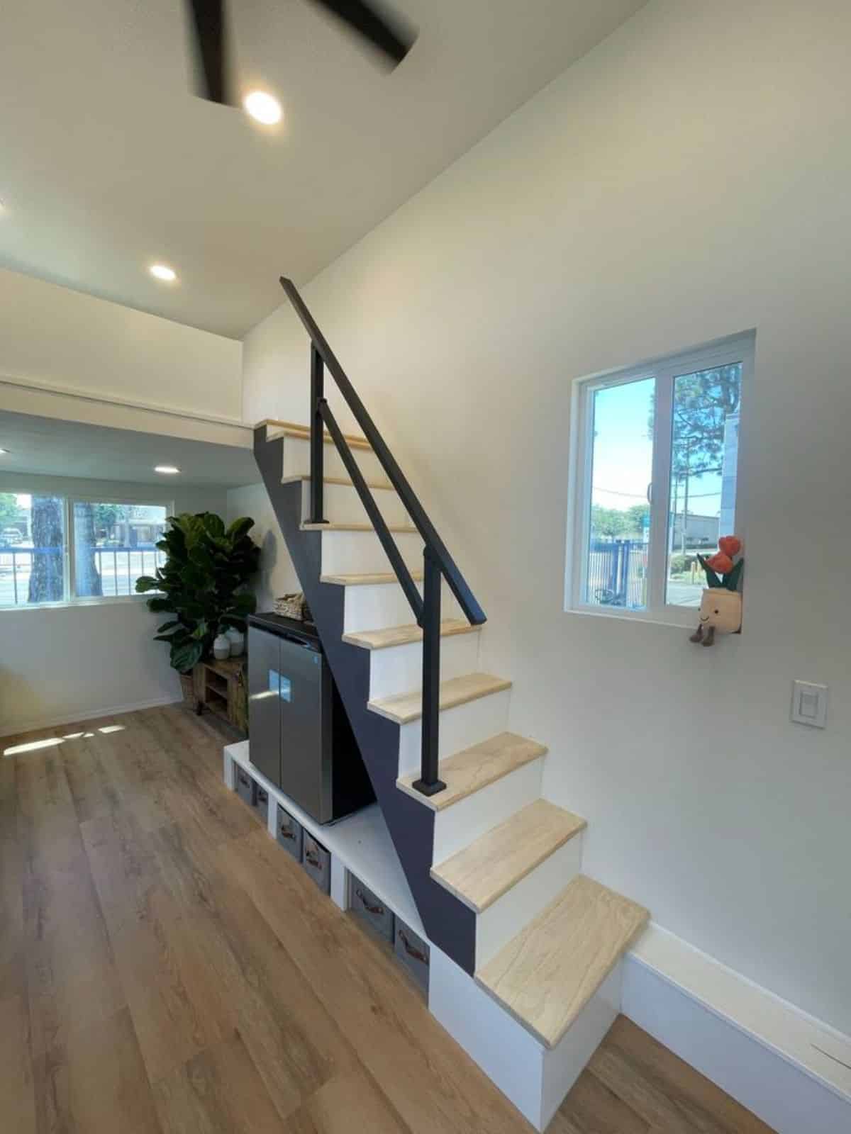 stairs leading to the loft bedroom has a storage cabinets underneath