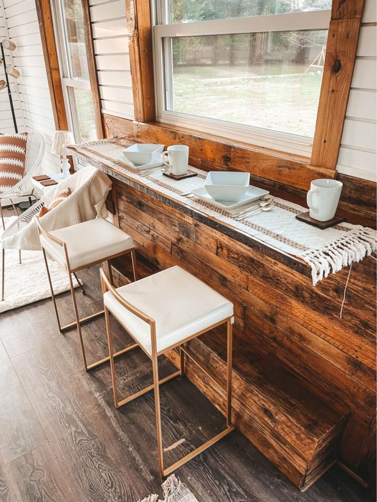 dining table with chairs besides the window of gorgeous tiny home