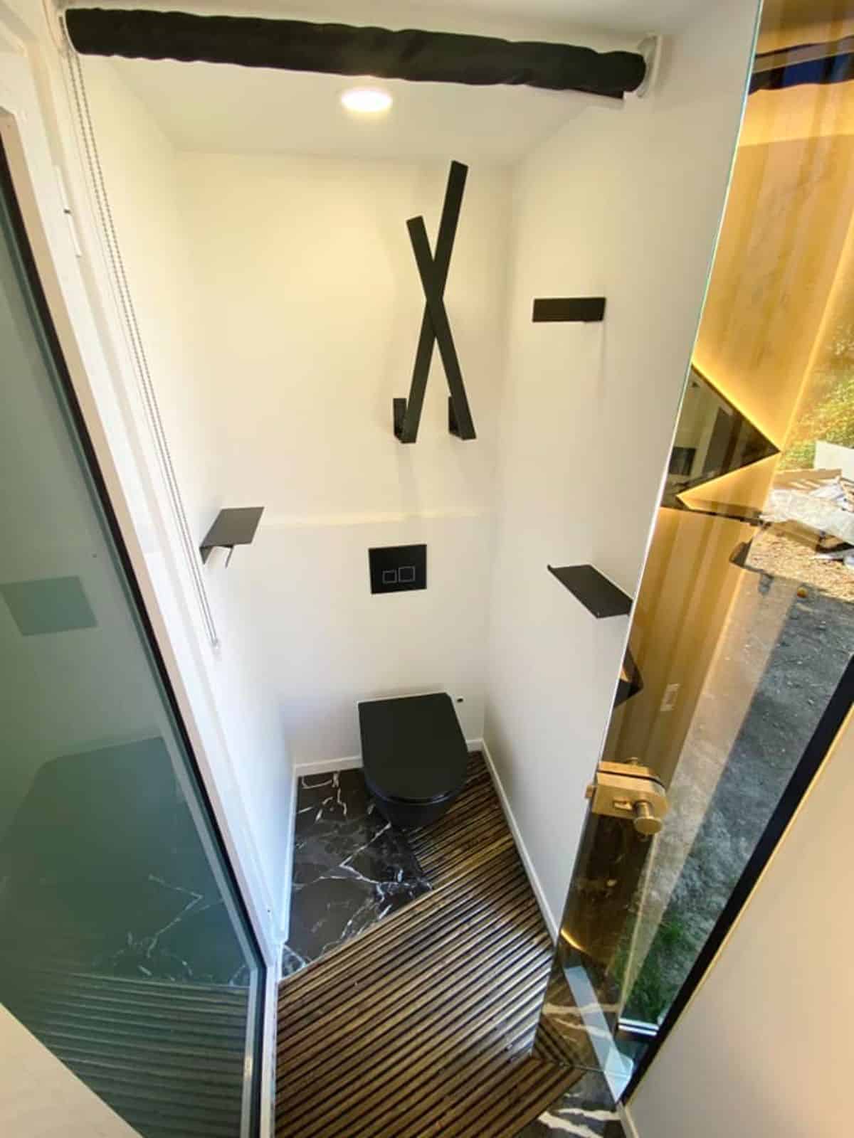 standard toilet installed in bathroom of micro mansion home