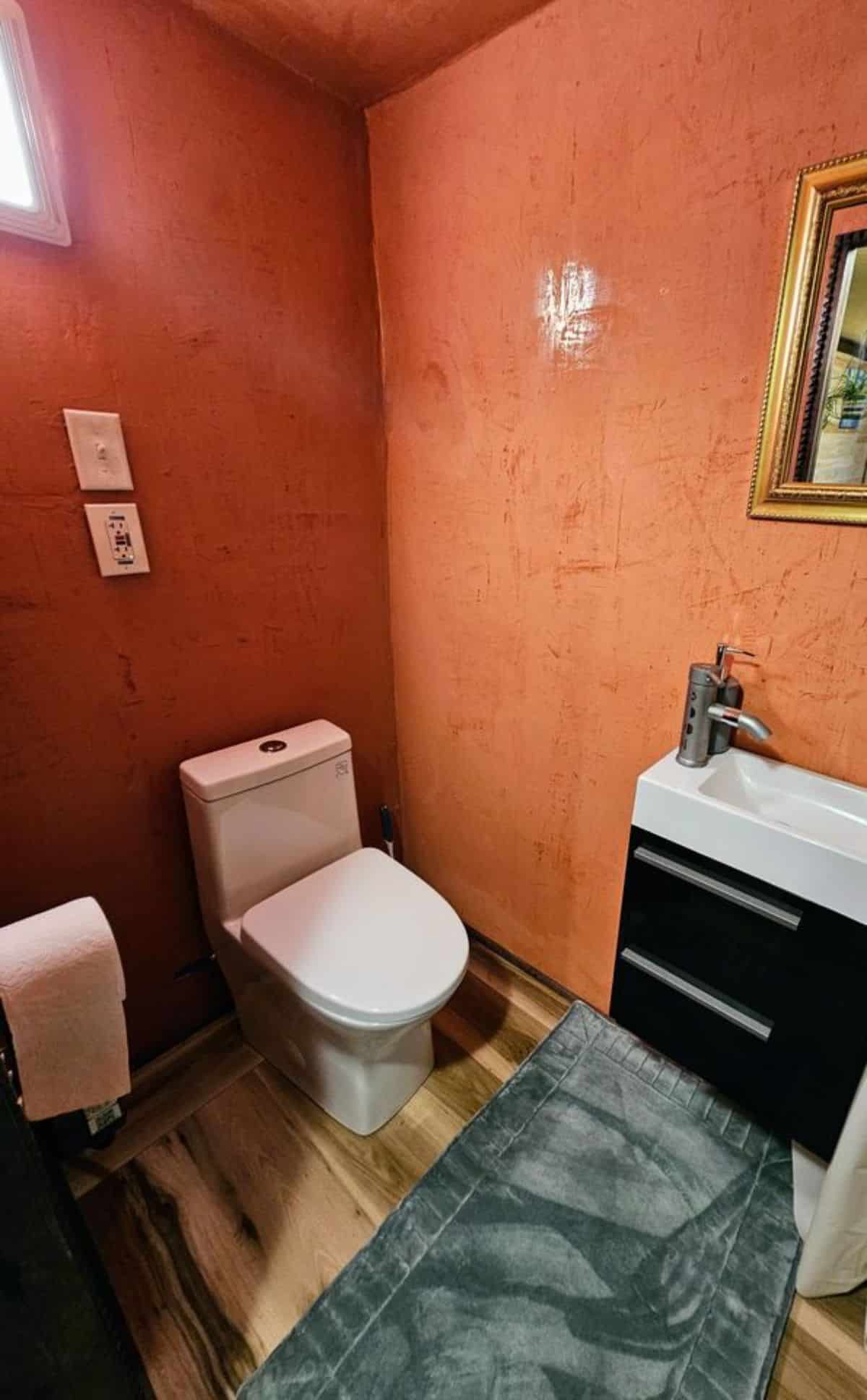 standard toilet installed in bathroom of reliable tiny house