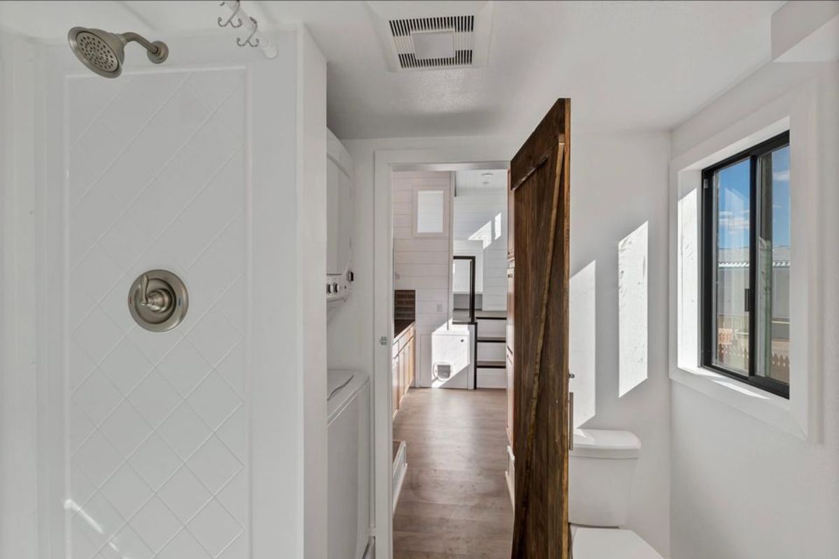 bathroom of roomy tiny home has all the standard fittings