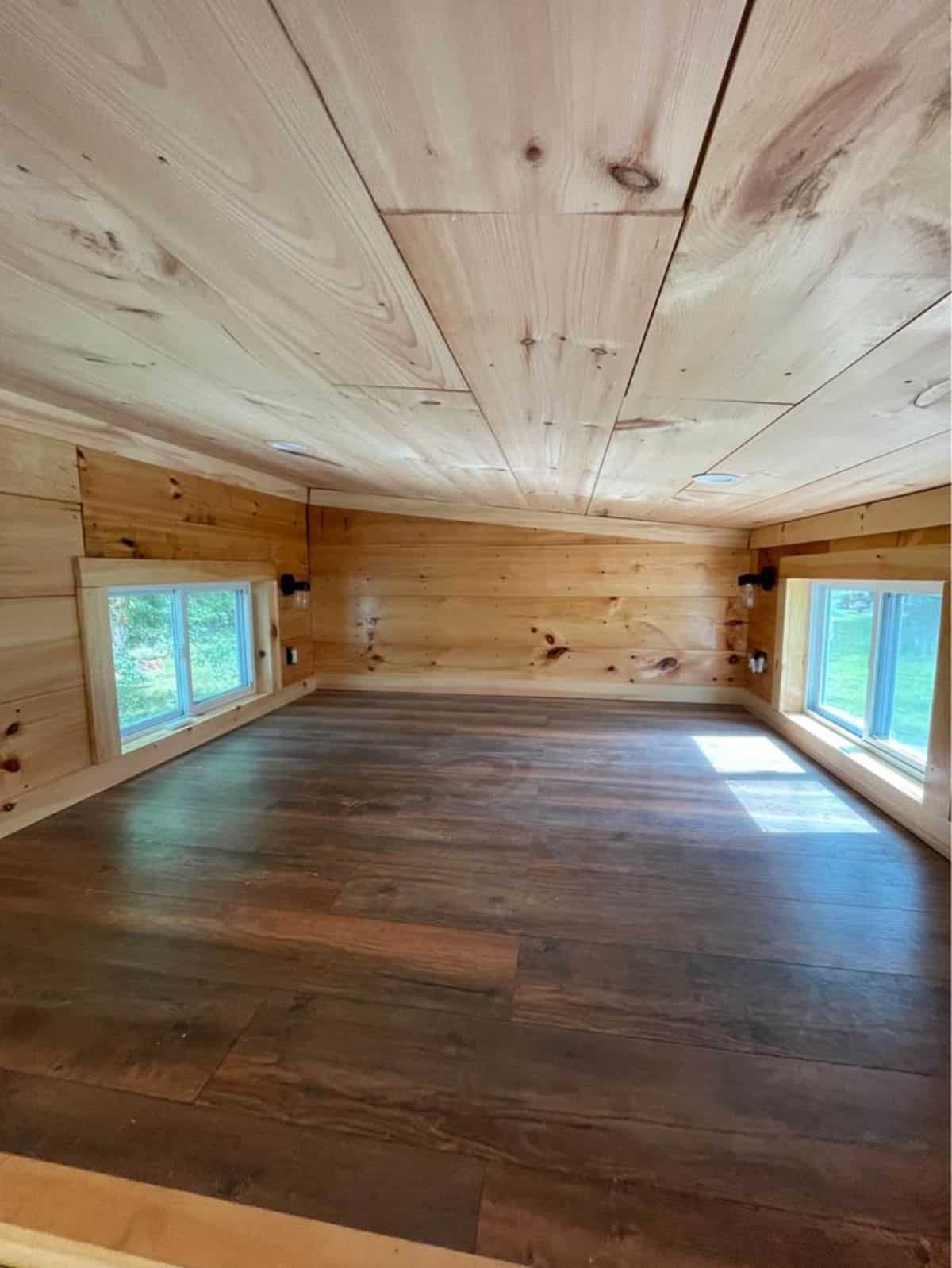 loft of tiny guest home is huge with multiple windows