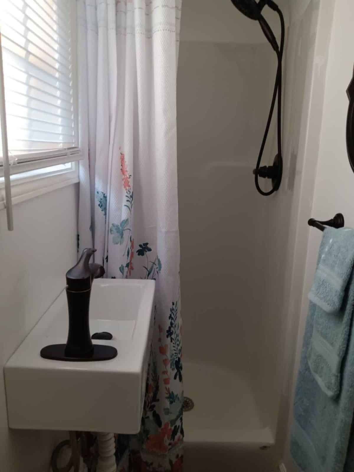 bathroom of turnkey ready tiny home has all the standard fittings and full length shower area