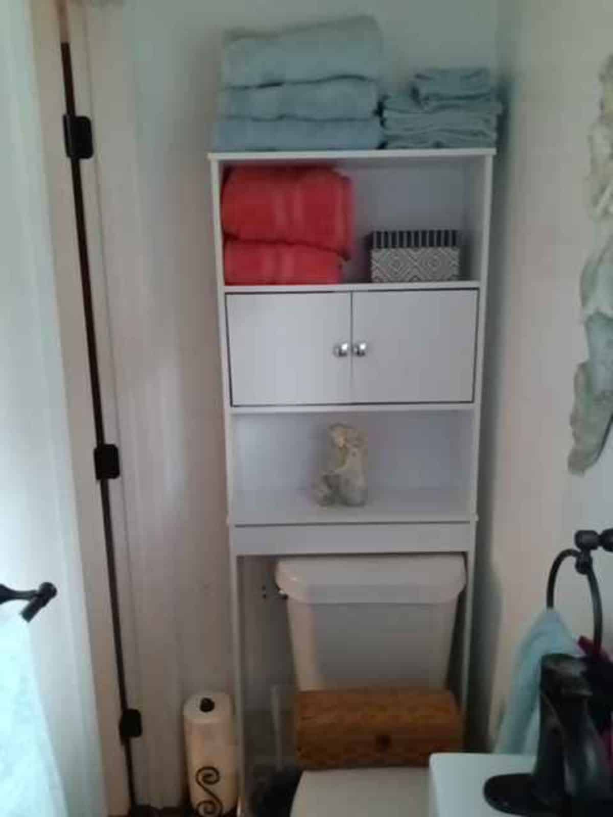 storage cabinets in the bathroom for toiletries and clothes