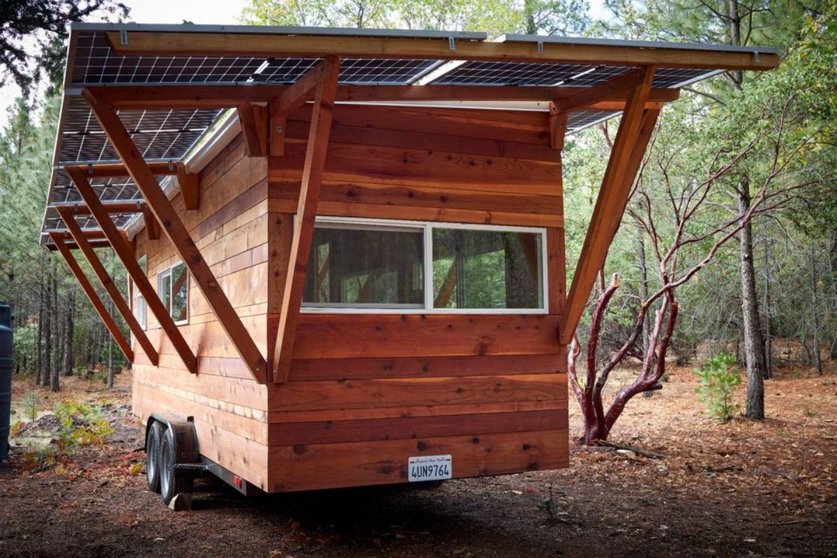 solar panels installed on the roof of 22' rustic tiny house from outside