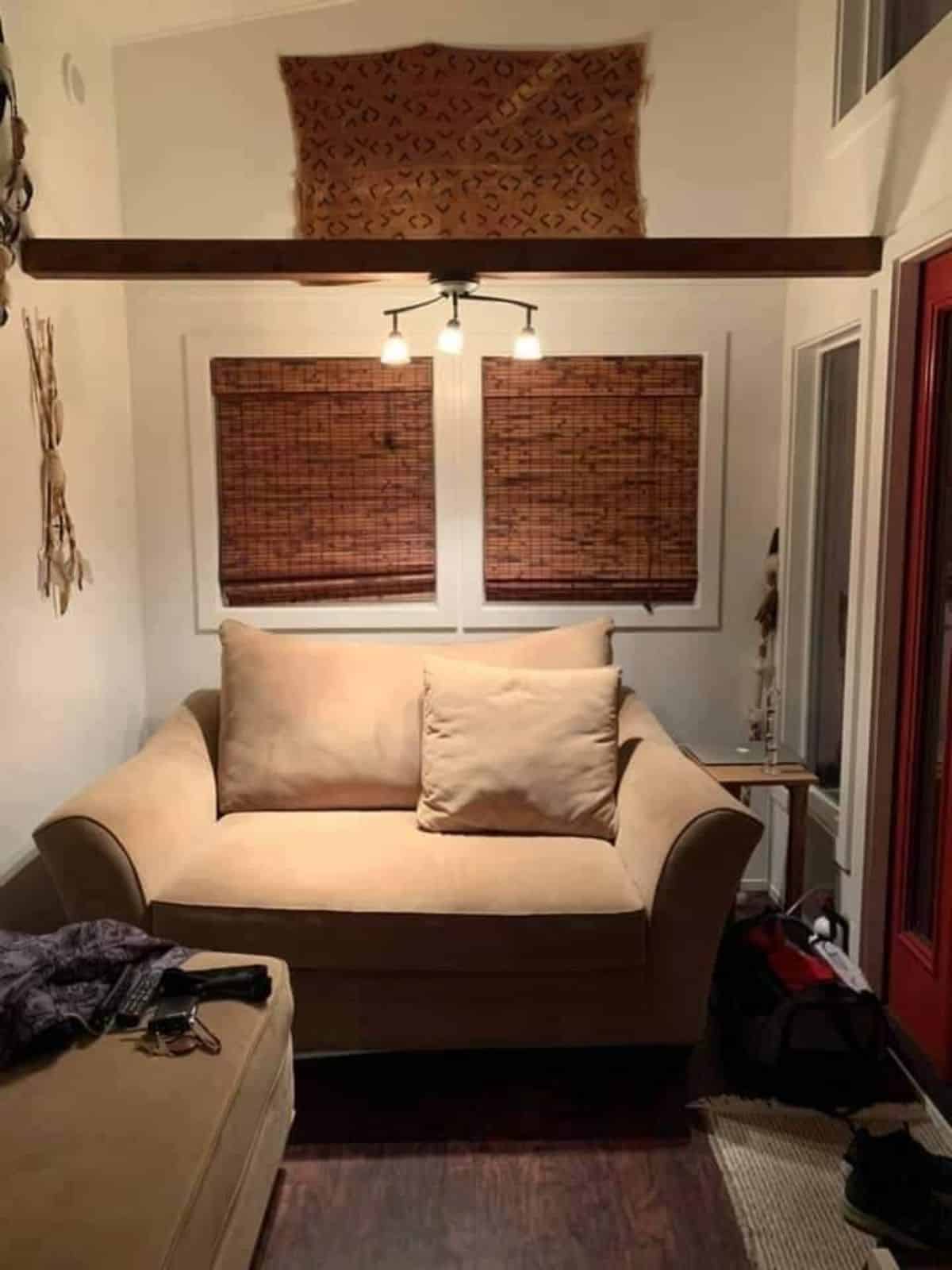 living area has a couch and has another loft above it