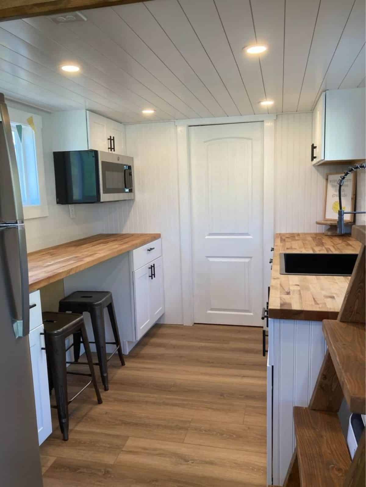 double galley kitchen area with storage cabinets