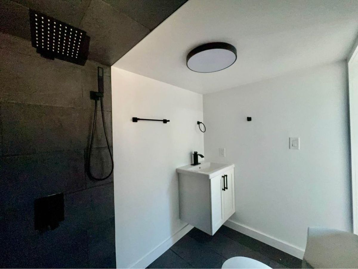 bathroom of affordable tiny home has all the standard fittings