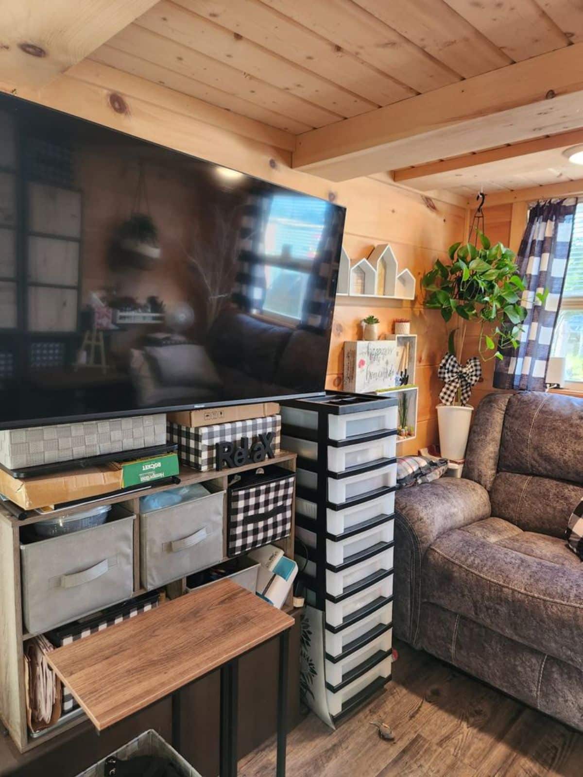 entertainment unit in the living area with wall mounted TV set