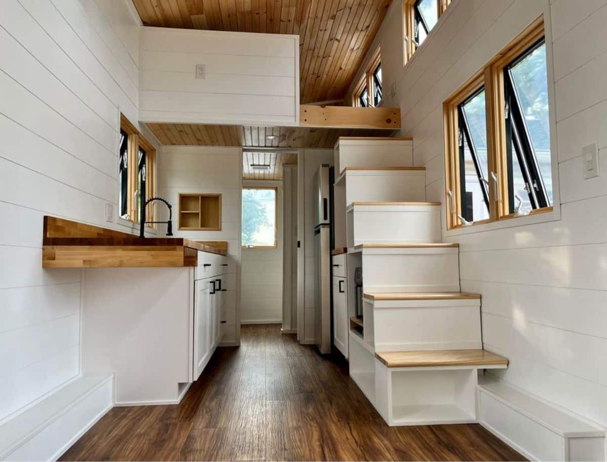 full length wooden interiors of two lofts tiny house