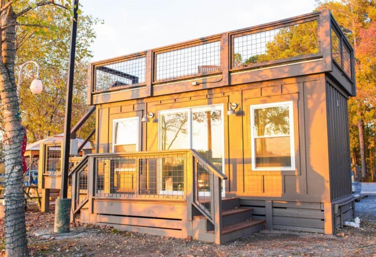 main entrance view of tiny home with a rooftop deck