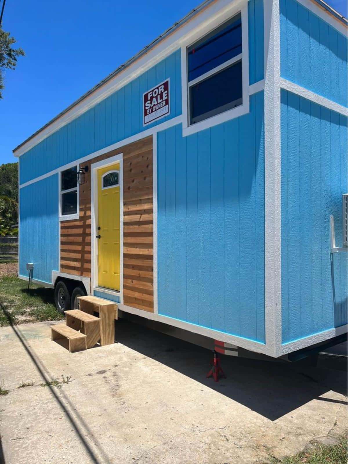 main entrance and stunning exterior of 2 BR tiny home on wheels