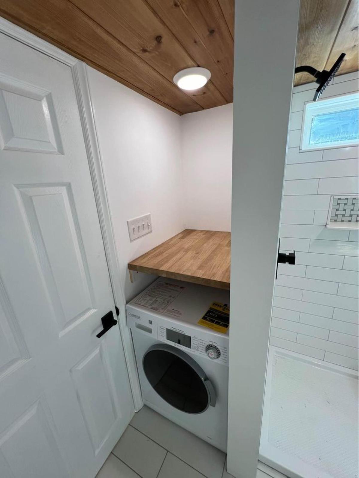 full length shower area with washer and dryer combo