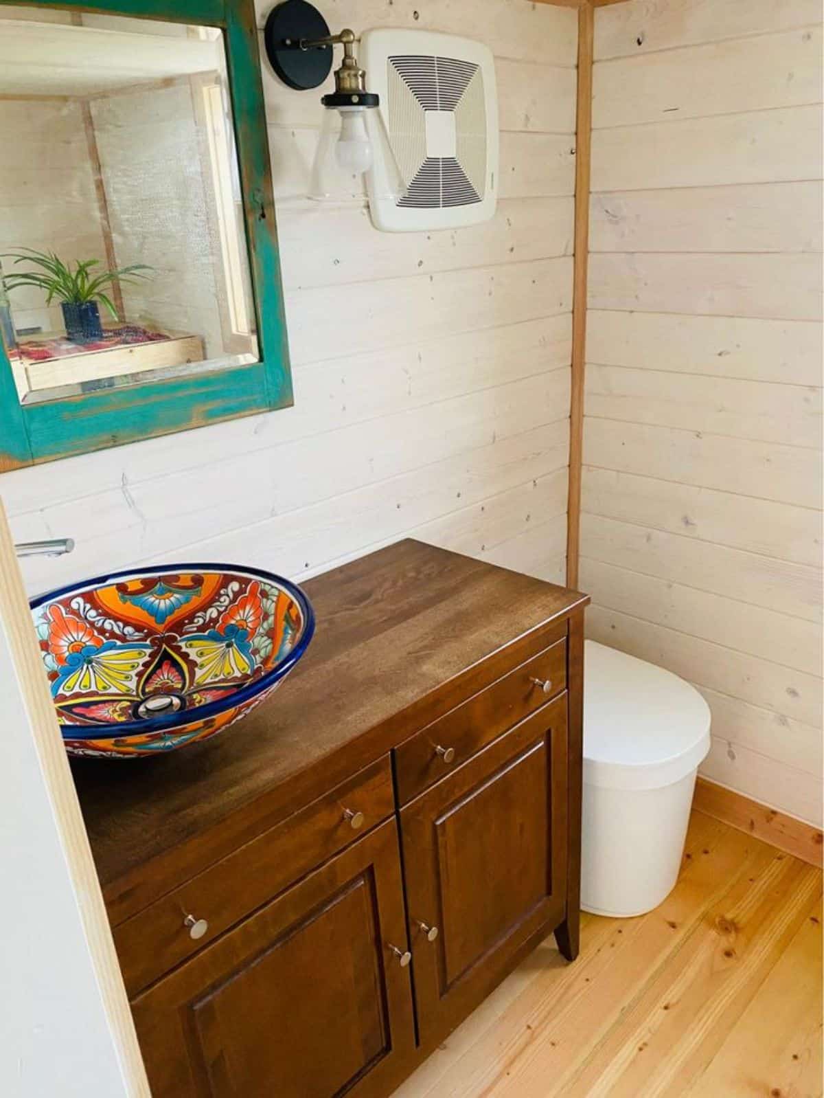 bathroom of chic tiny home has all the standard fittings and composting toilet