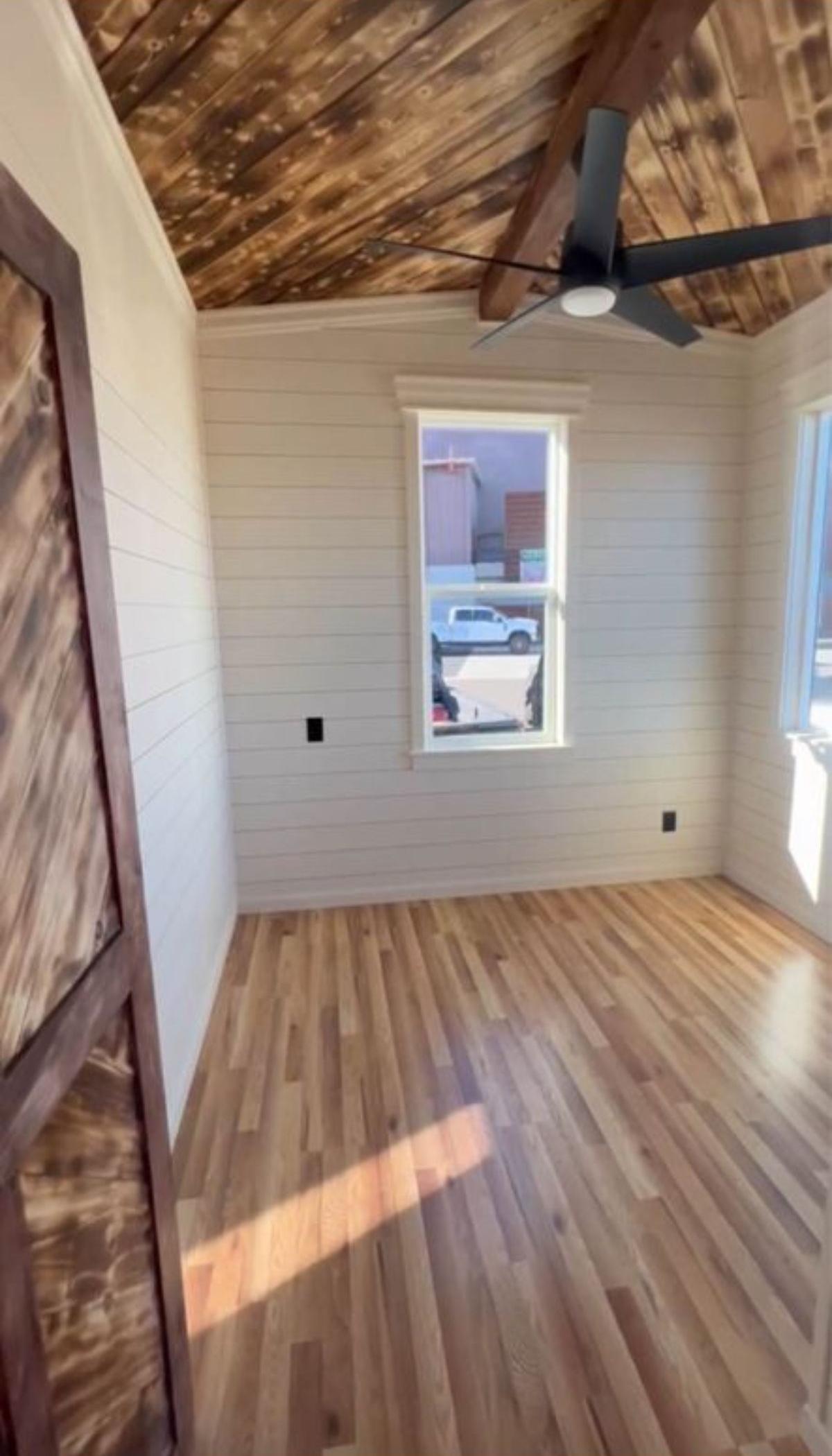 bedroom of airy tiny home is spacious