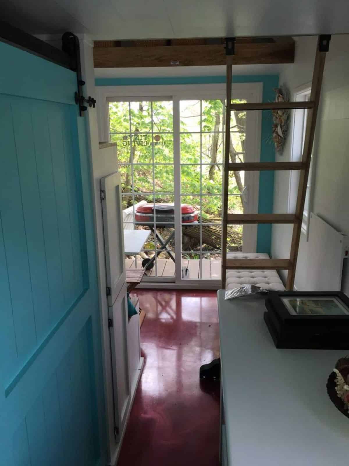 glass main entrance door of super tiny house from inside