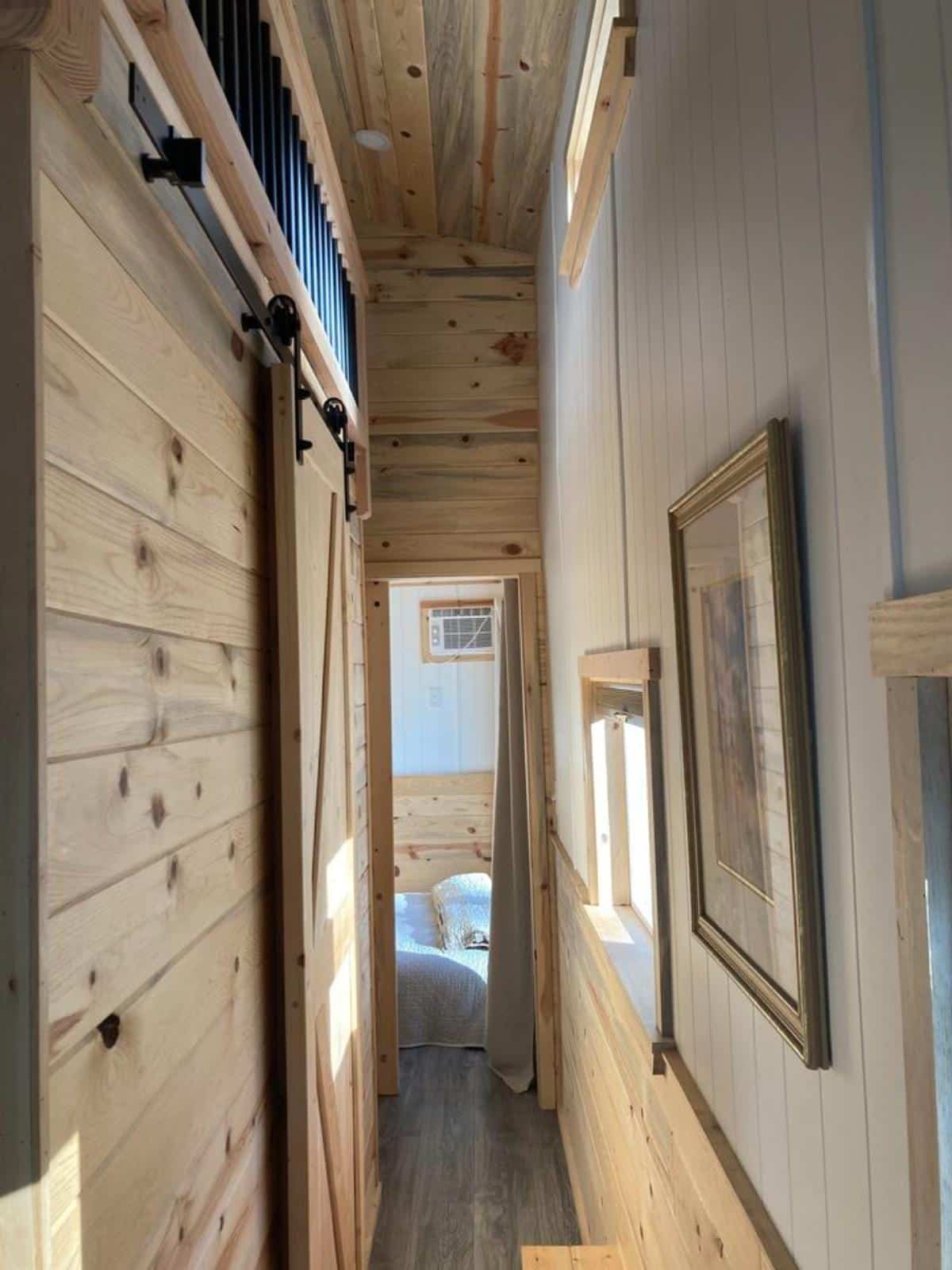 pathway towards the master bedroom of 32’ tiny house on wheels