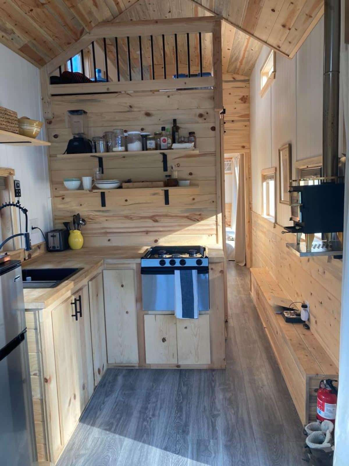 L shaped kitchen area of 32’ tiny house on wheels
