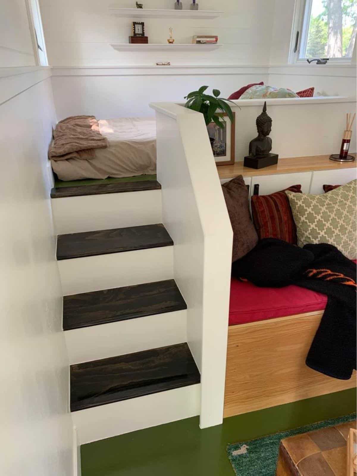 small stairs leading to sleeping area right above the living area