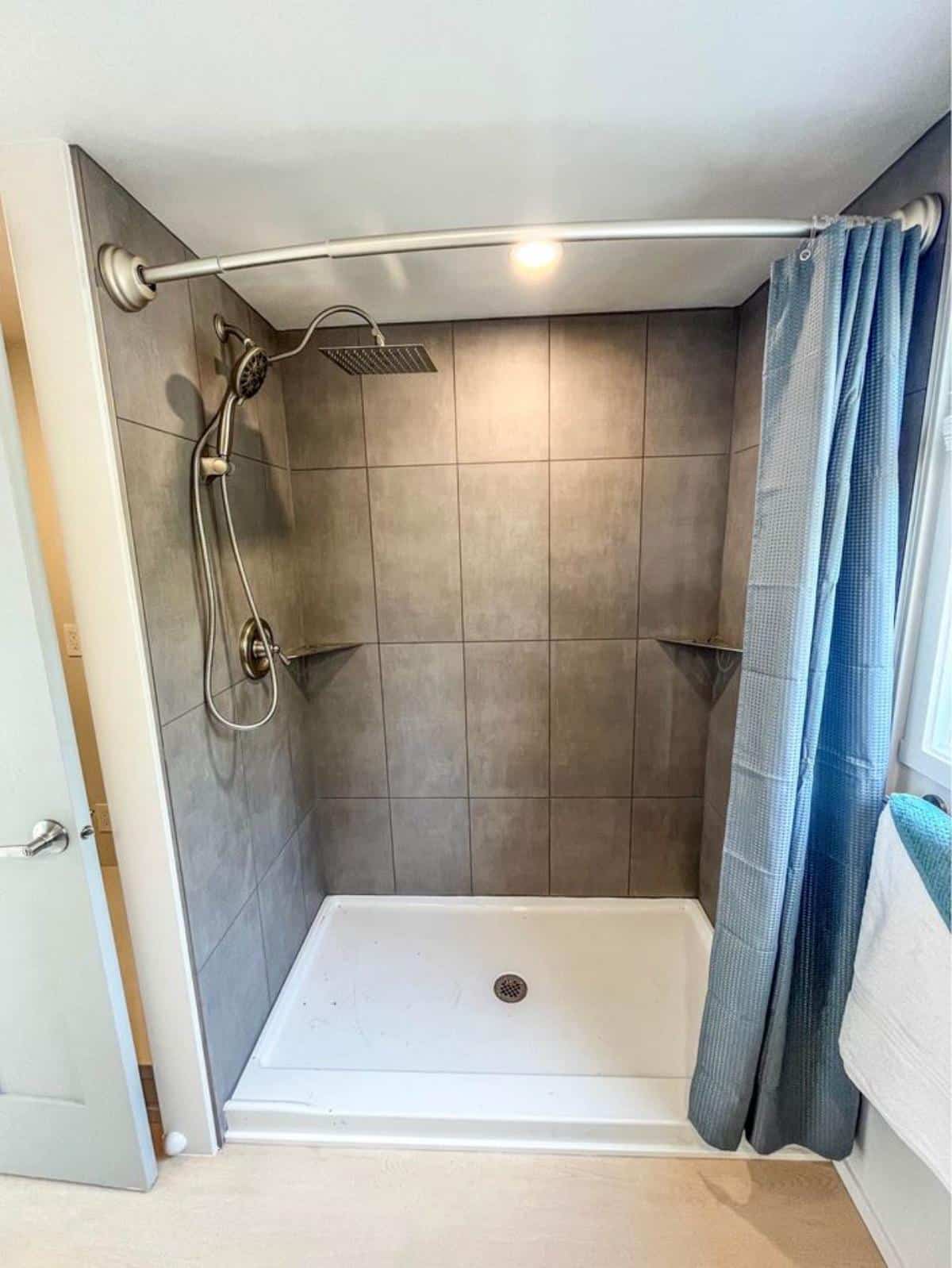 full length shower area in bathroom of brand new custom built tiny home