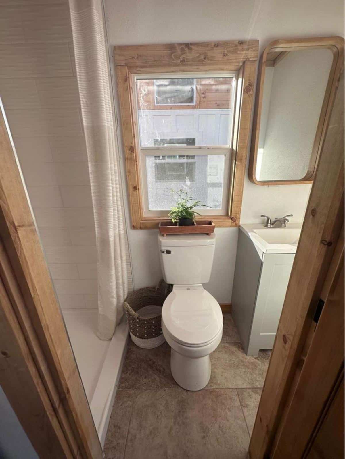 standard toilet in bathroom of minimalist tiny house