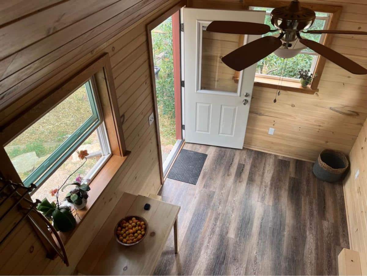 wooden floor, walls and full height of sleek tiny home