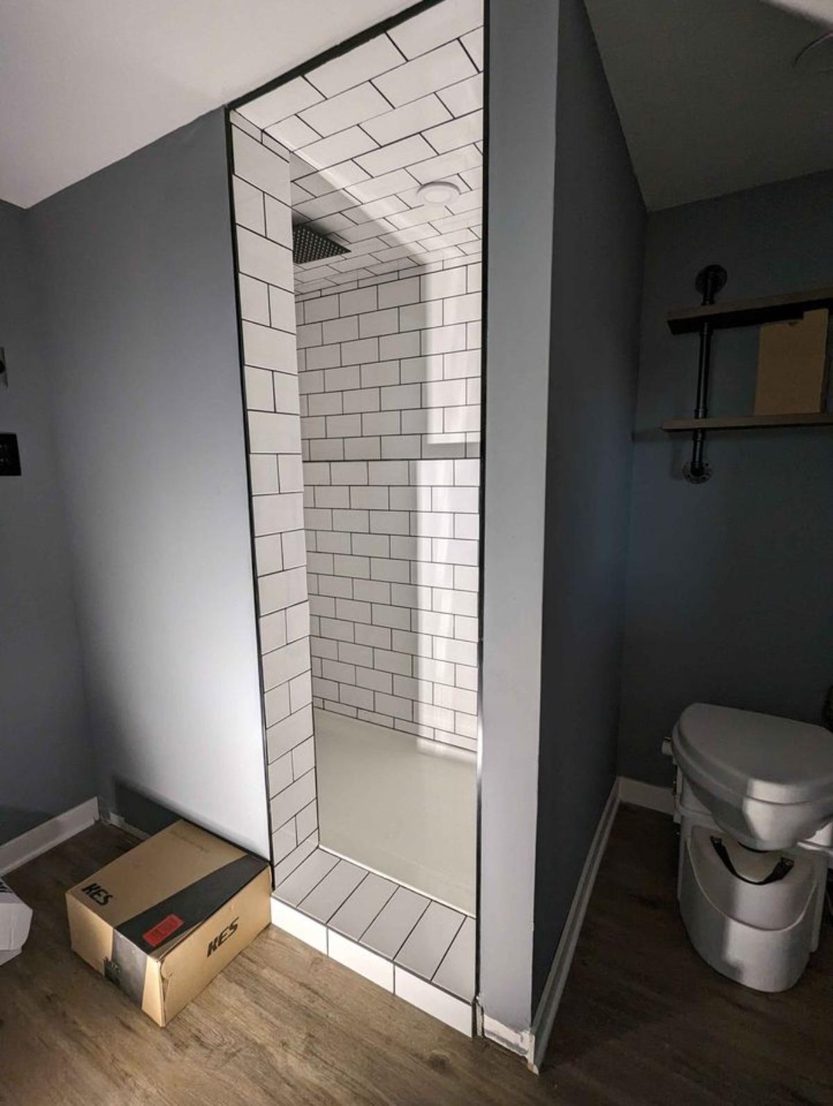 full tiled length shower area in bathroom